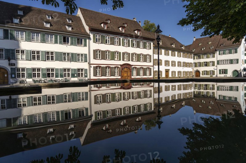 Cathedral houses reflected in the fountain on Muensterplatz in Basel