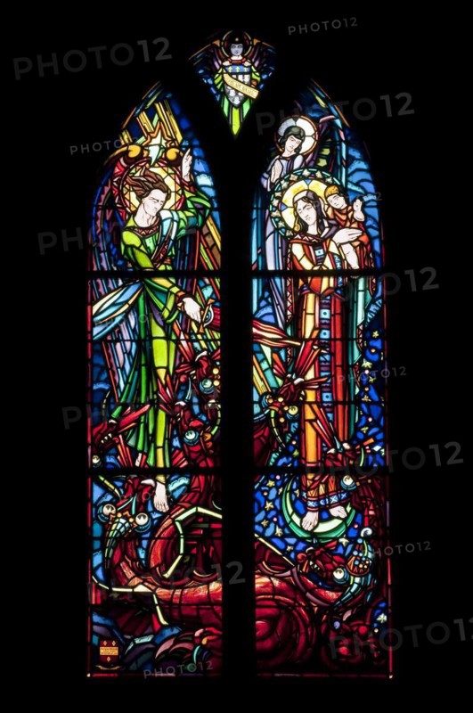 Stained-glass window picturing Saint Michael fighting dragon