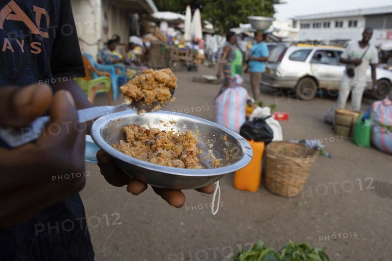 Man with a plate of food at a market