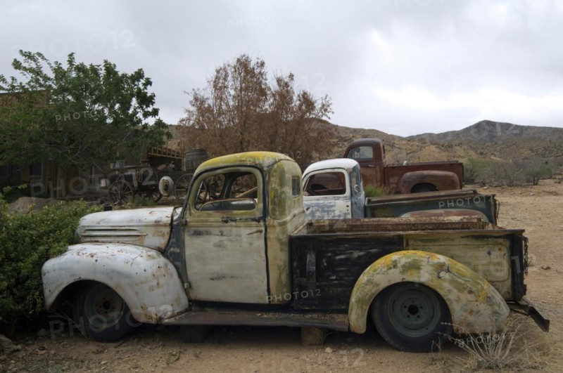 Old vintage pickup trucks along the Route 66 at the general store of the ghost town Hackberry in Arizona