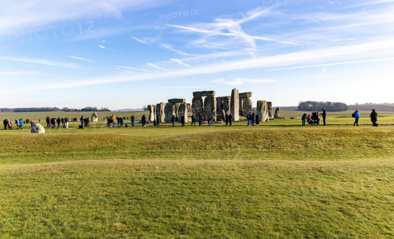 Tourists view standing stones of Neolithic henge