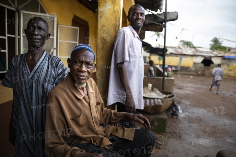 Three men in Bomeh Village at the KissyRoad dumpsite
