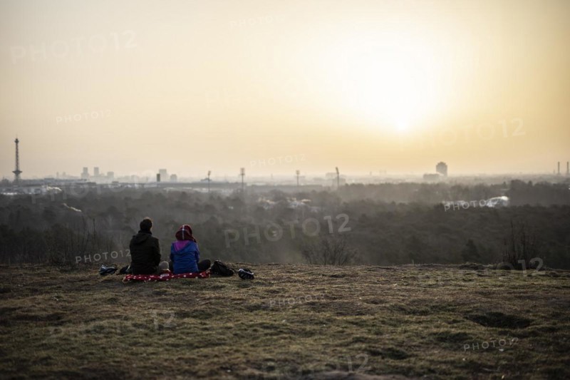 Two people silhouetted against the rising sun in Berlin