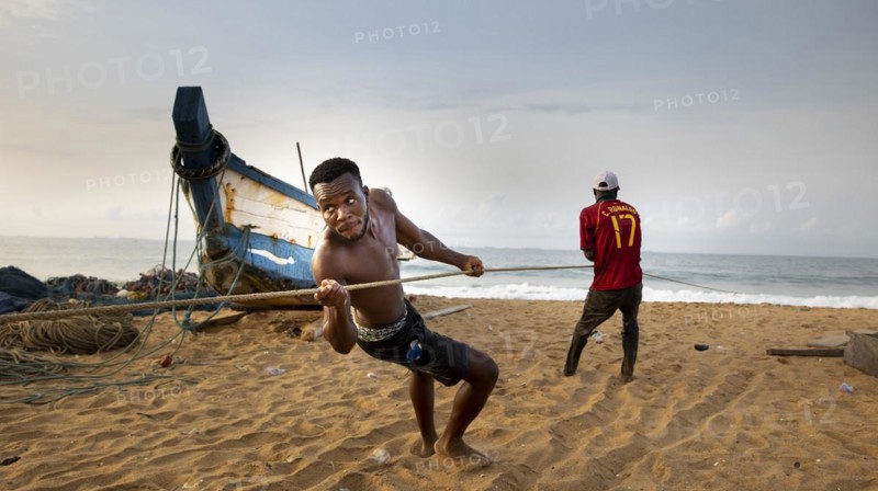 Young fisherman helps to land a catch