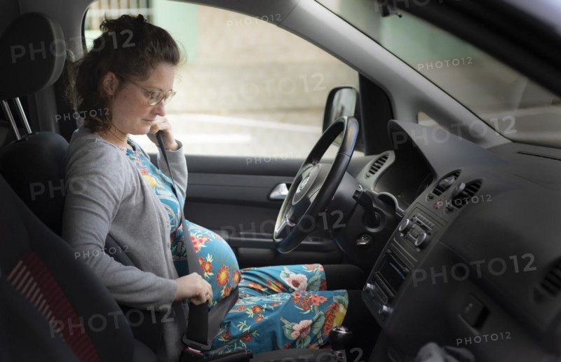 Subject: Pregnant woman wearing a seat belt in the car