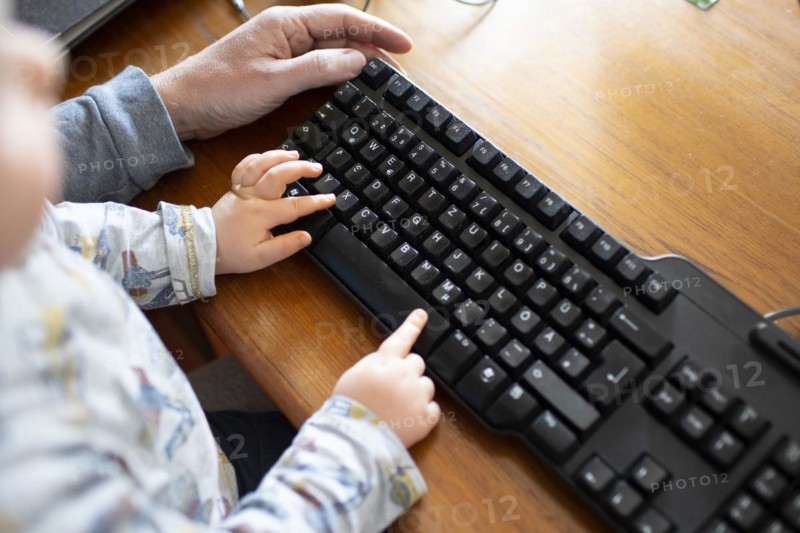 Subject: Man in a home office and a small child