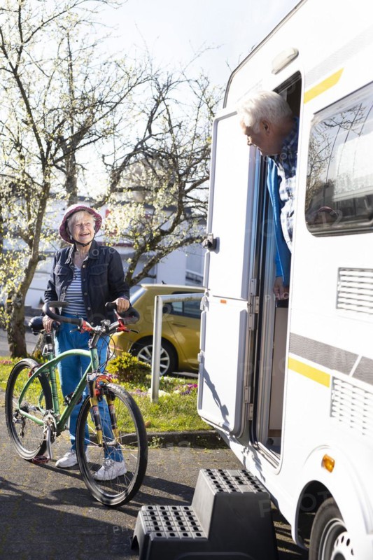 Subject: Pensioners with mountain bikes at their caravan