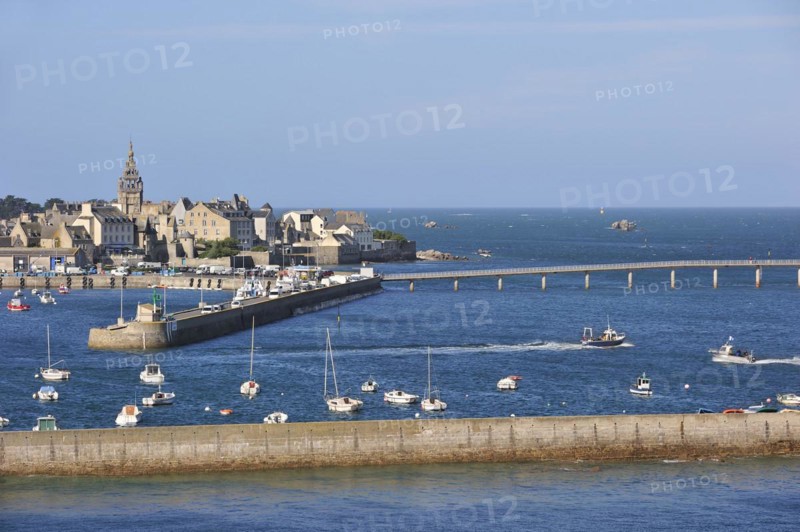 The church Notre-Dame de Croaz Batz and sailing boats and fishing boats in the harbour of Roscoff