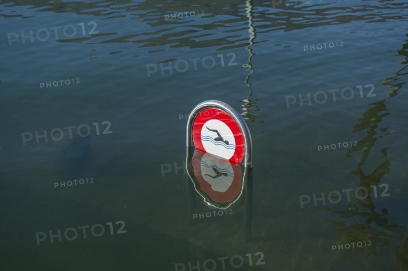 Signboard on flooding alpine lake Lago Maggiore