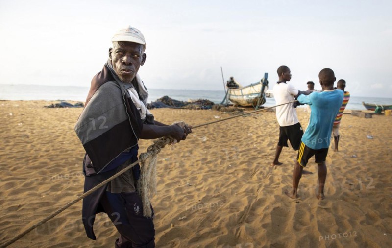 Old fisherman helps to land a catch