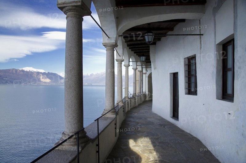 Eremo di Santa Caterina del Sasso on the Lake Maggiore with Snow-capped Mountain in Leggiuno in Lombardy