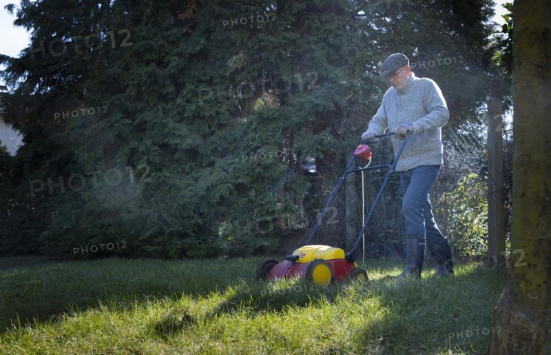 Subject: Man tends his lawn.