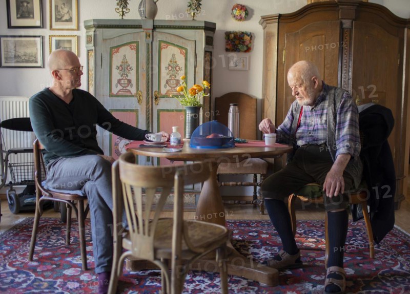 Subject: Father and son sitting together at the table
