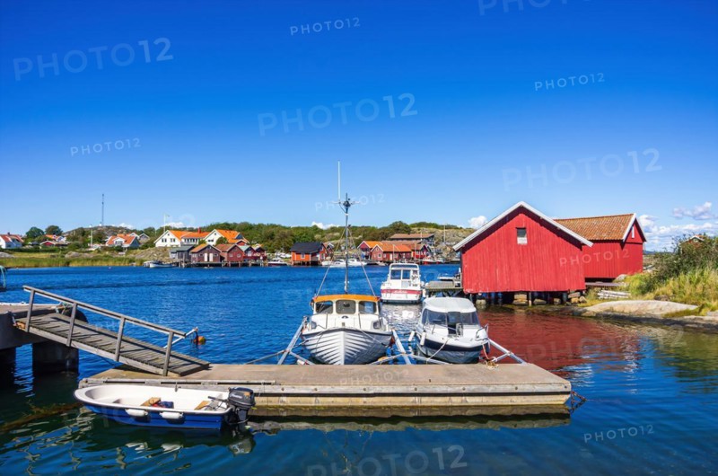 Mooring with boats and boathouses in the picturesque village of Langegaerde