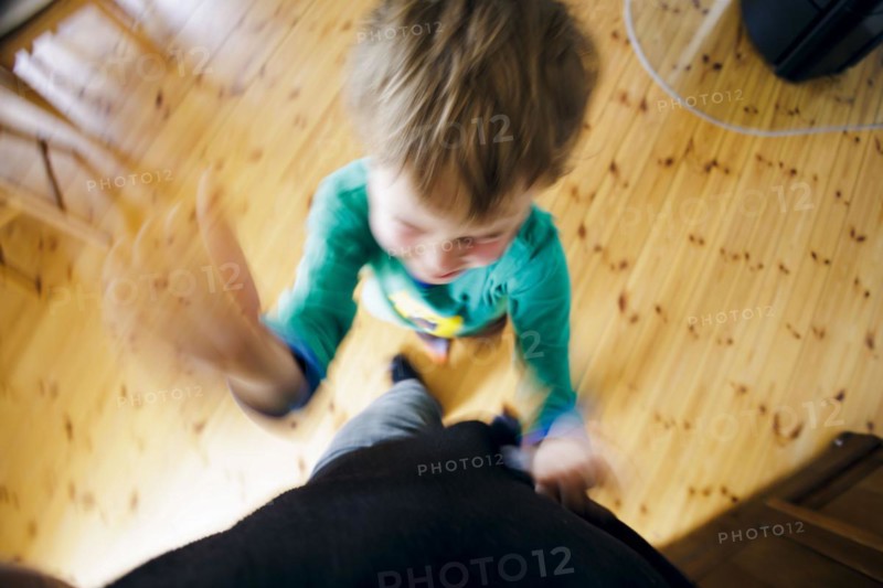 Symbolic photo on the subject of children's tantrums. A boy beats his father with his fists. Berlin