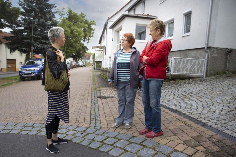 Neighbourhood. Women on the street are talking to each other.