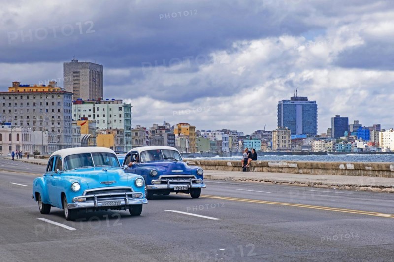 Two vintage 1950s Chevrolet cars on the Malecon
