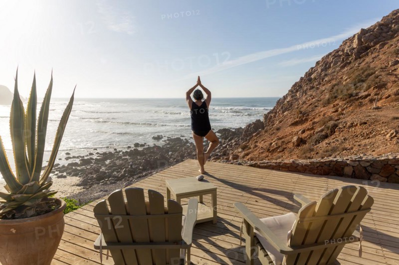 Woman performing yoga Tree pose Vrikshasanayoga