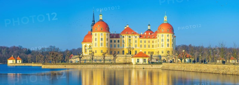 Exterior view of Moritzburg Castle in winter with half-frozen castle pond from the south