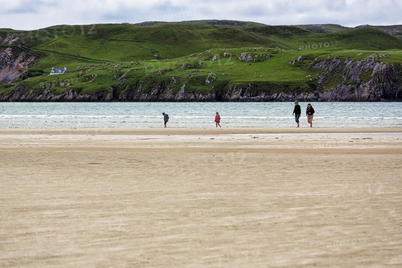 Walkers on the sandy beach