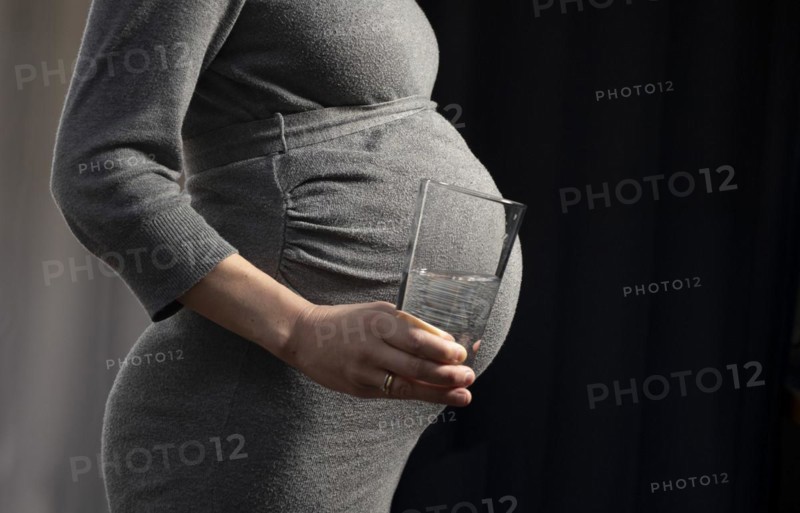 Pregnant woman with water glass