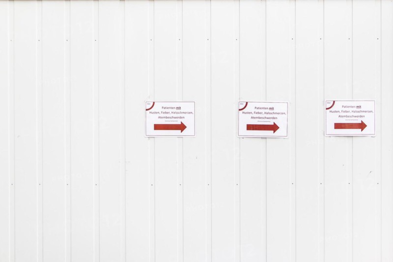 Three notices with the inscription 'Patients with cough