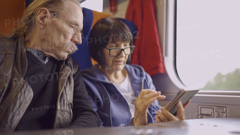 Elderly couple travel by train