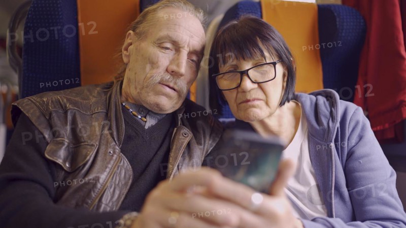 Elderly couple travel by train