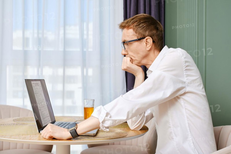 Middle aged man submitting individual income tax return form from home