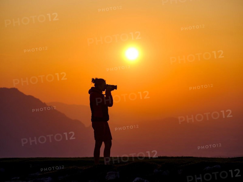 Silhouette of a photographer at sunset