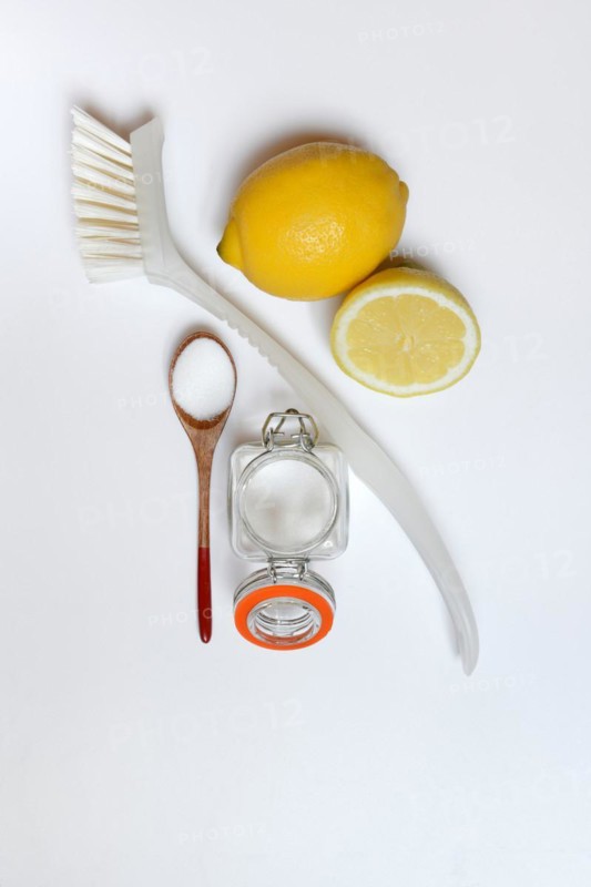 Citric acid in wooden spoon and glass container
