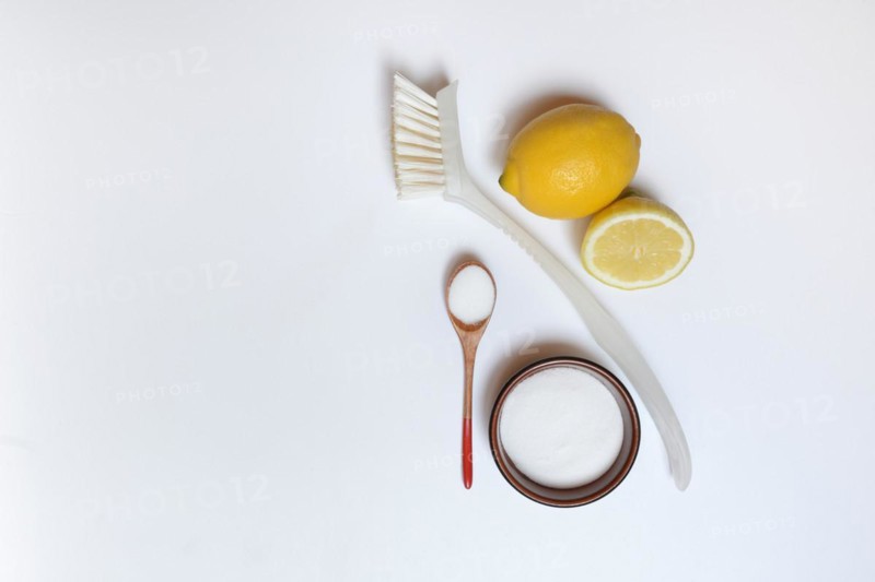 Citric acid in wooden spoon and small bowl