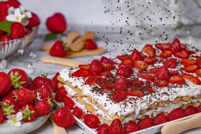 Tiramisu with strawberries and flying chocolate sprinkles