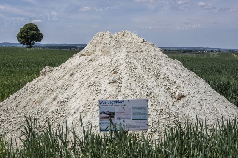 Natural lime fertiliser with information board on a field in the Donaumoos