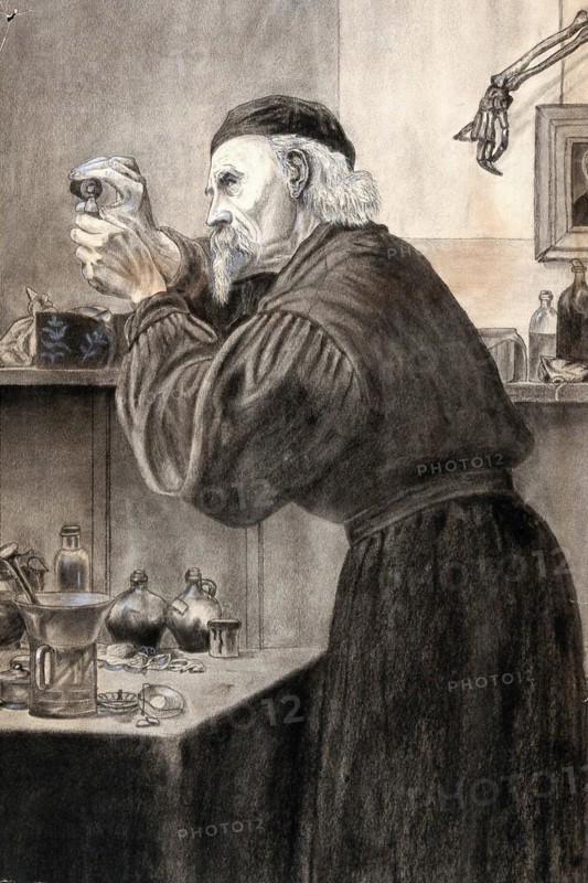 A chemist in a smock and skull cap pouring a liquid from a bottle
