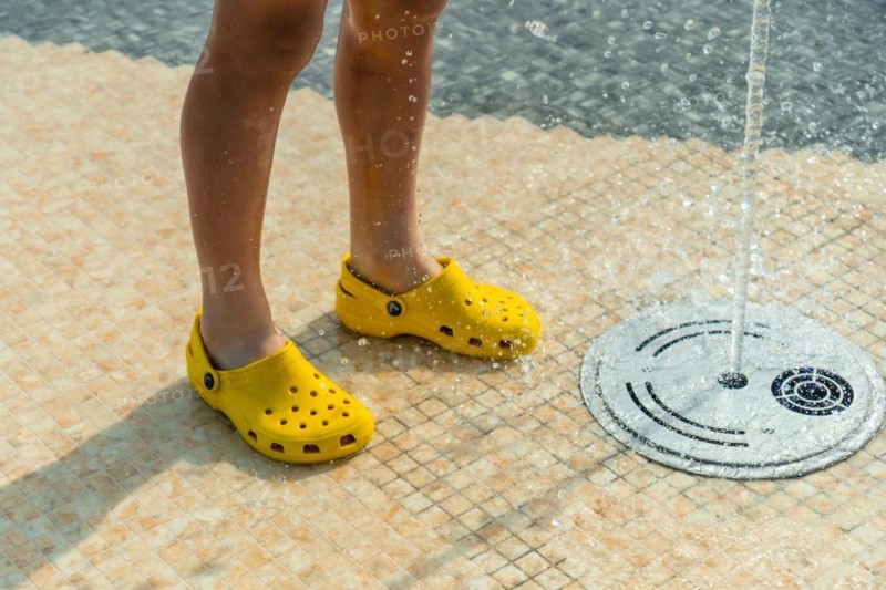 Children enjoying summer pool with water jets