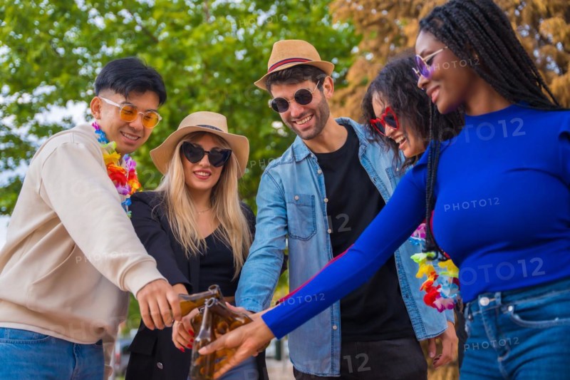 Multi ethnic friends partying in a park