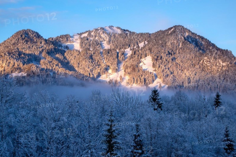 Sun shines on the wintry mountain Brauneck