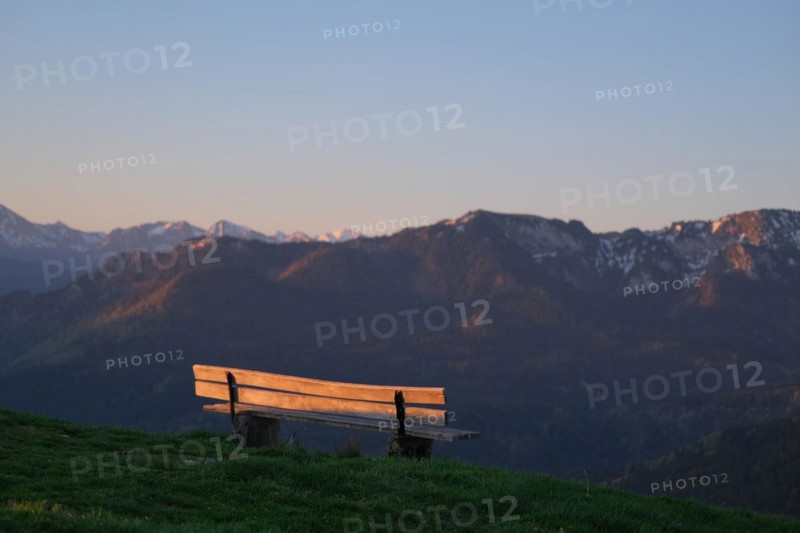 Viewpoint or bench in the sunrise with a view of the mountains of the Bavarian Alps and the Karwendel
