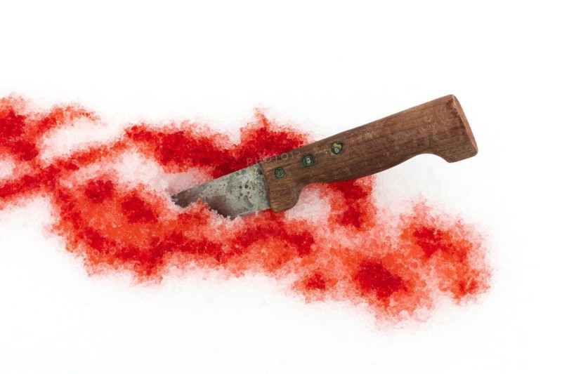 Knife and traces of blood on the snow