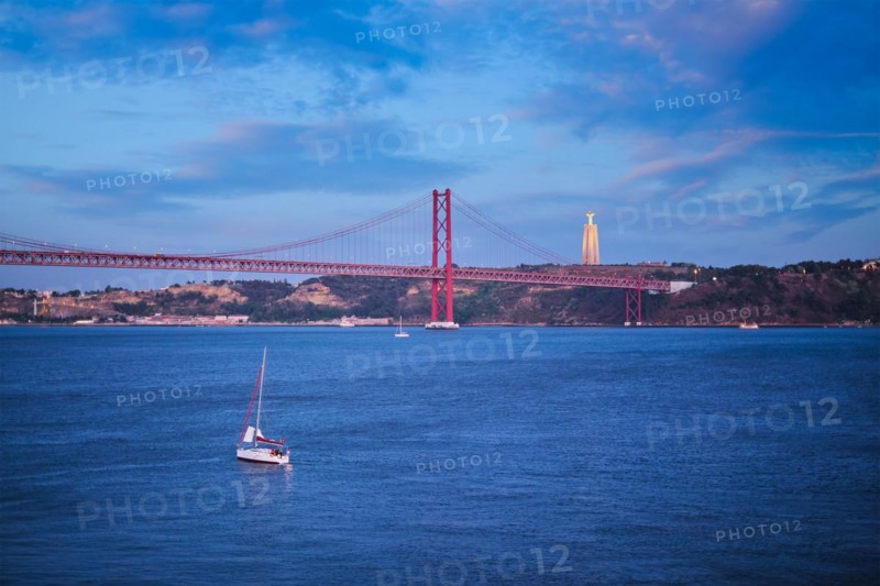 View of 25 de Abril Bridge famous tourist landmark over Tagus river