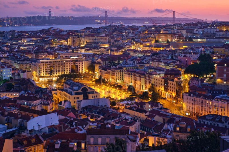 Evening aerial view of Lisbon famous view from Miradouro da Senhora do Monte tourist viewpoint of Alfama and Mauraria old city districts