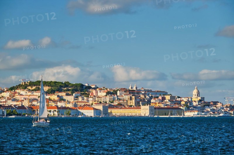 View of Lisbon over Tagus river from Almada with yachts tourist boats on sunset