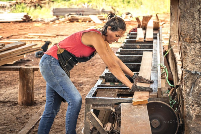 Female worker in work uniform in a sawmill