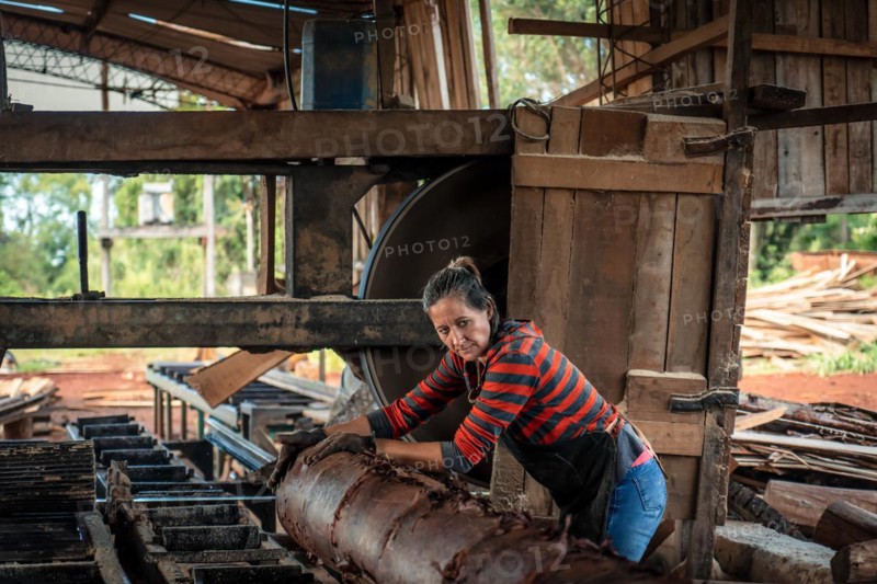 Female worker in work uniform in a sawmill