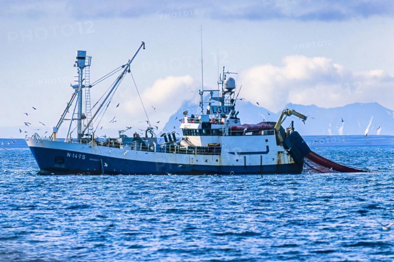 Russian Shrimp trawlers fishing in arctic waters outside a rocky coast