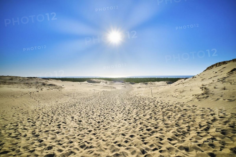 View of bright sun over nordic dunes of Curonian spit