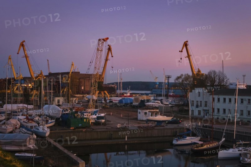 Beautiful sunset port area with portal cranes