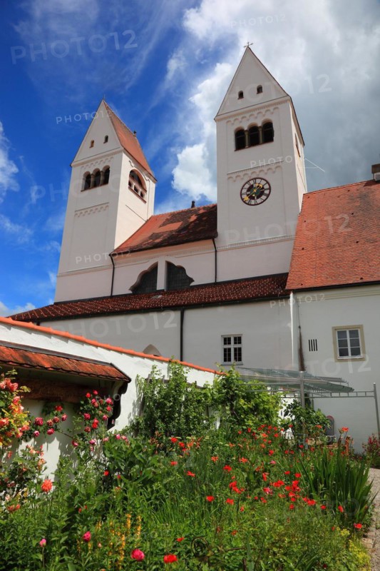 West façade with porch and monastery garden