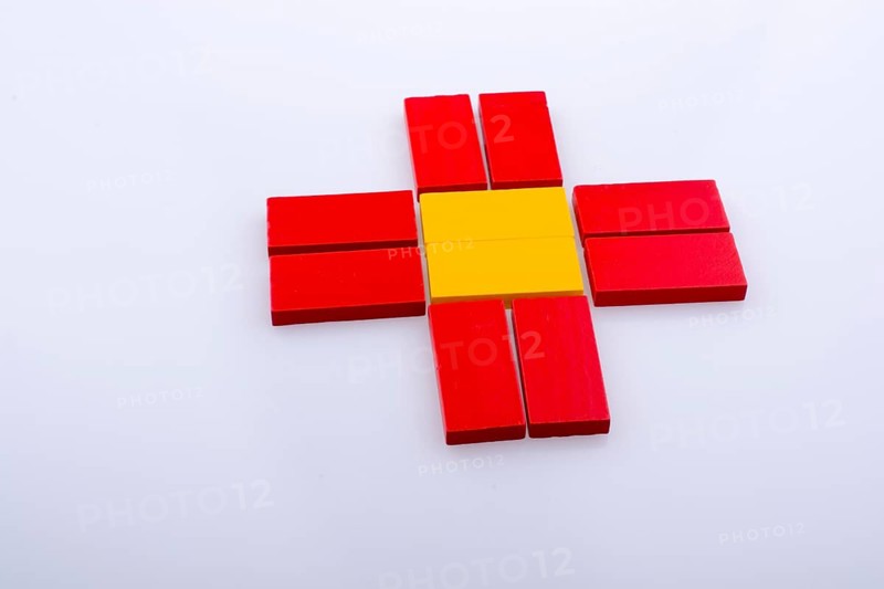 Colorful Domino Blocks forming a Sun shape on a white background